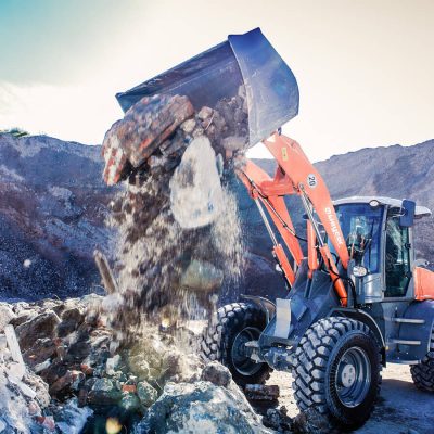 Weycor wheel loader dumping construction waste on a stockpile.