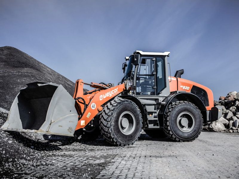 Weycor AR 620 Radlader auf Schotterplatz vor Gesteinshaufen.